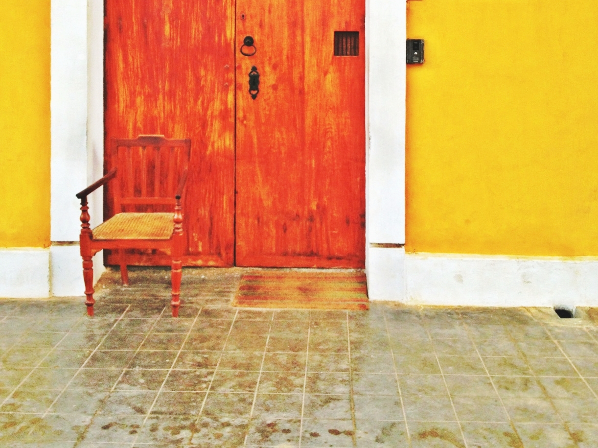Chair in front of orange doors 